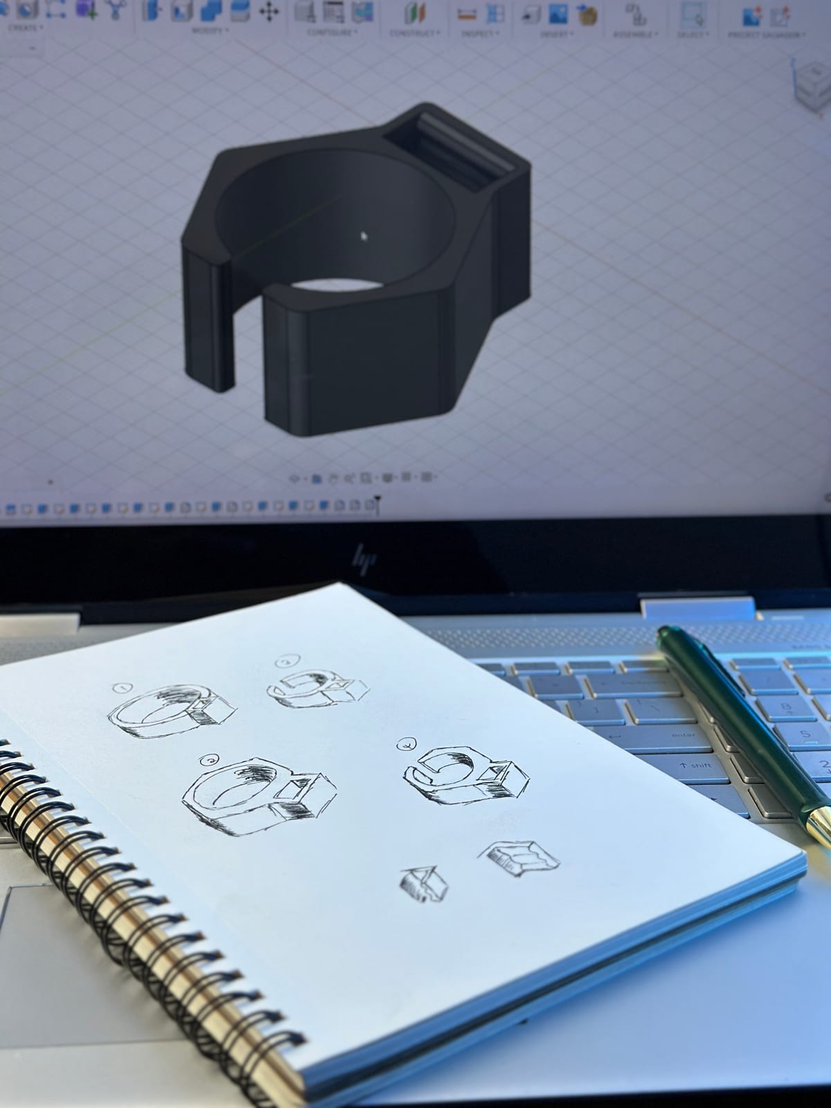 Hand-sketched concept iterations next to the finished 3D CAD model at Tynmas Labs